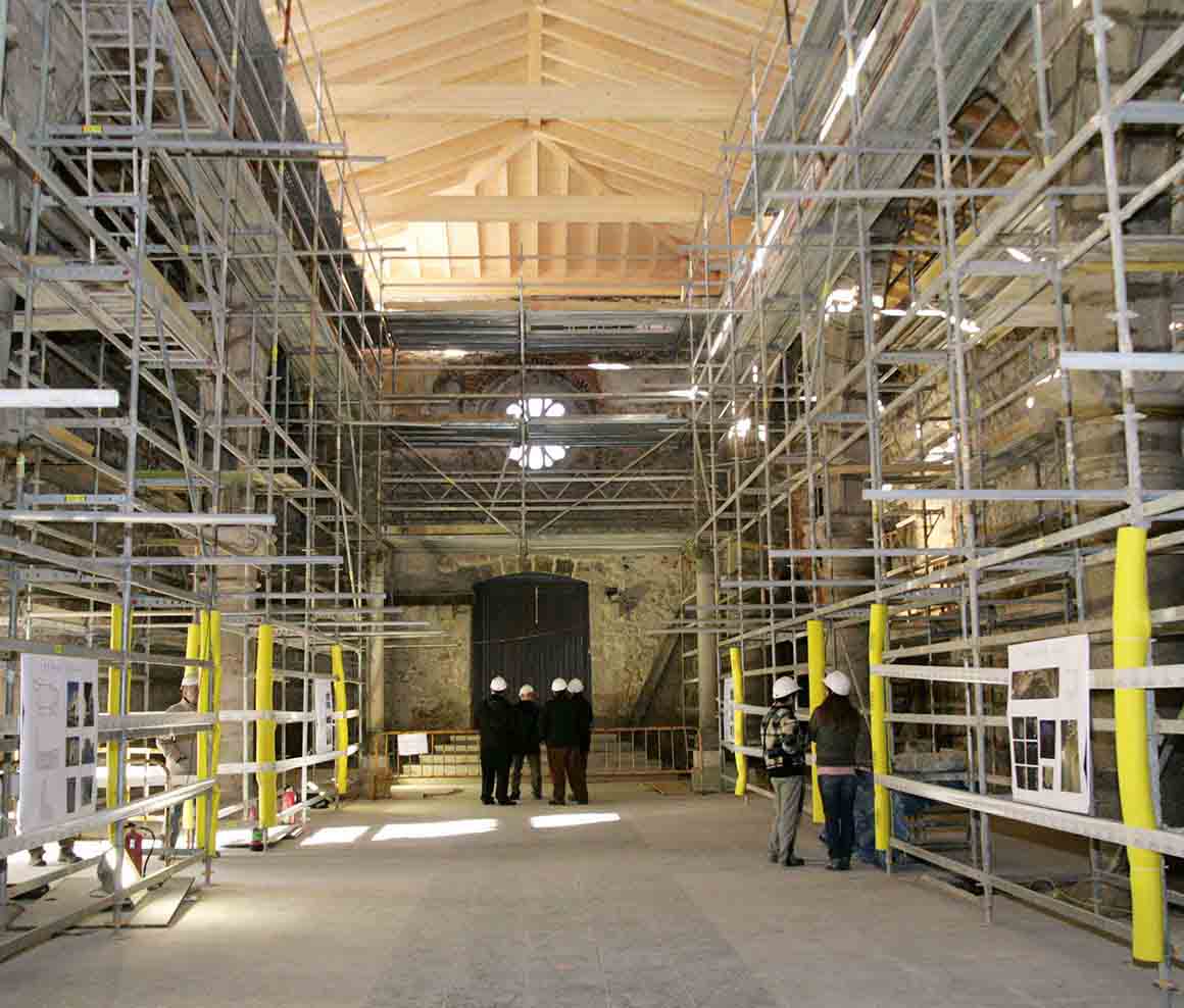 Interior de un edificio rodeado de andamios durante la restauración.